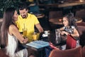 Family with two children having great time in a cafe after shop Royalty Free Stock Photo