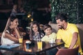 Family with two children having great time in a cafe after shopping Royalty Free Stock Photo