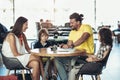 Family with two children having great time in a cafe after shop Royalty Free Stock Photo