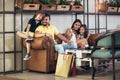 Family with two children having great time in a cafe after shop Royalty Free Stock Photo