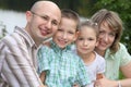 Family with two children in park near pond Royalty Free Stock Photo