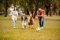 Family with two children playing football together in an Royalty Free Stock Photo