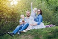 Family with two children rest in the summer garden