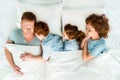 family with two children sleeping together