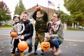 Family with two children on traditional party for celebrations halloween near New York