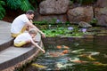 Feeding koi fish Royalty Free Stock Photo