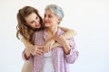 Family two generations old mother and adult daughter on white Royalty Free Stock Photo