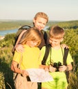 Family with two kids looking at map, family travel. Mother and c