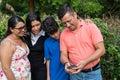 A family with two teenagers uses a cell phone to make a video call Royalty Free Stock Photo