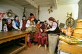 Family in Ukrainian native costumes gathered to cook traditional dish kutia for celebrating Christmas Eve. Ukrainian