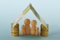 Family under house made of money - Concept of family, home and financial protection Royalty Free Stock Photo