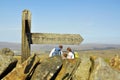 Family under signpost on top of hill Royalty Free Stock Photo