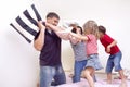 Family Union Ideas. Happy Caucasian Family of Four Having a Playful Funny Pillow Fight on Bed Indoors with Positive Emotions Royalty Free Stock Photo