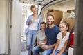 Family Unloading Boxes From Removal Truck On Moving Day Royalty Free Stock Photo