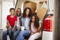 Family Unloading Boxes From Removal Truck On Moving Day Royalty Free Stock Photo