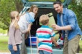 Family unloading car trunk while on picnic Royalty Free Stock Photo