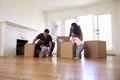 Family Unpacking Boxes In New Home On Moving Day Royalty Free Stock Photo