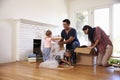 Family Unpacking Boxes In New Home On Moving Day Royalty Free Stock Photo