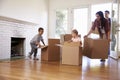 Family Unpacking Boxes In New Home On Moving Day Royalty Free Stock Photo