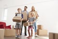 Family Unpacking Boxes In New Home On Moving Day Royalty Free Stock Photo