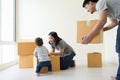Family unpacking boxes in new home on moving day. Royalty Free Stock Photo