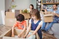 Family unpacking cardboard boxes Royalty Free Stock Photo