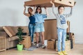 Family unpacking cardboard boxes at new home