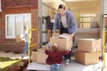 Family Unpacking Moving In Boxes From Removal Truck Royalty Free Stock Photo
