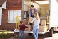 Family Unpacking Moving In Boxes From Removal Truck Royalty Free Stock Photo