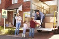 Family Unpacking Moving In Boxes From Removal Truck Royalty Free Stock Photo