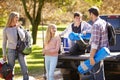 Family Unpacking Pick Up Truck On Camping Holiday