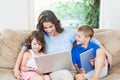 Family using laptop, digital tablet and mobile phone Royalty Free Stock Photo