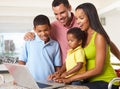 Family Using Laptop In Kitchen Together Royalty Free Stock Photo