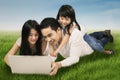 Family using laptop on the meadow Royalty Free Stock Photo