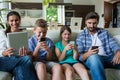 Family using laptop and mobile phone in living room Royalty Free Stock Photo