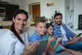 Family using laptop and mobile phone in living room at home Royalty Free Stock Photo