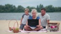 Family using laptop to talk to grandmom