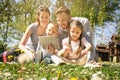 Family using tablet outdoors. Royalty Free Stock Photo