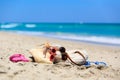 Family vacation concept - bag, suncream, sandals on beach