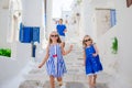 Family vacation in Europe. Father and kids at narrow street on Mykonos Island, in Greece Royalty Free Stock Photo