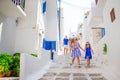 Family vacation in Europe. Father and kids at narrow street on Mykonos Island, in Greece Royalty Free Stock Photo