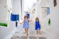 Family vacation in Europe. Father and kids at street of typical greek traditional village on Mykonos Island, in Greece Royalty Free Stock Photo