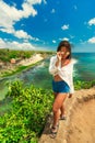 Excited girl standing on top mountain cliff and enjoy amazing view nature landscape tropical island Bali Royalty Free Stock Photo