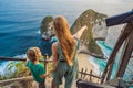 Family vacation lifestyle. Happy mother and son stand at viewpoint. Look at beautiful beach under high cliff. Travel