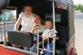 Family on vacation, mother and kids sitting in tuk-tuk, having fun