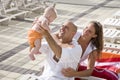 Family vacation, relax on pool deck lounge chairs Royalty Free Stock Photo