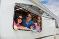 Family vacation, RV travel with kids, happy parents with children have fun on holiday trip in motorhome, caravan camper