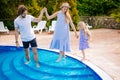 Family vacation in summer. Parents with kid having fun near swimming pool Royalty Free Stock Photo