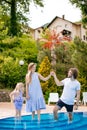 Family vacation in summer. Parents with kid having fun near swimming pool Royalty Free Stock Photo