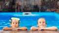 Family vacation and tourism concept. Happy children in the swimming pool. Water games and water fun for kids Royalty Free Stock Photo